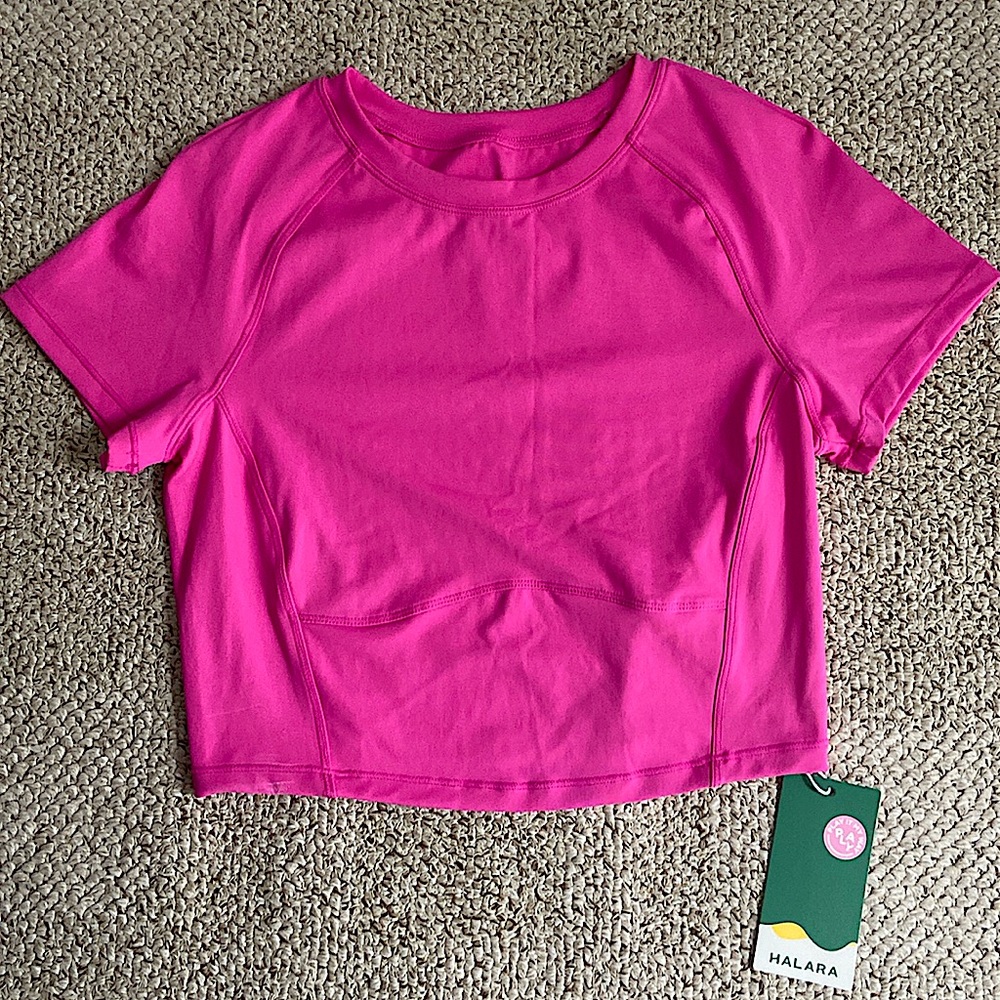 This is a pink cropped workout top from Halara.